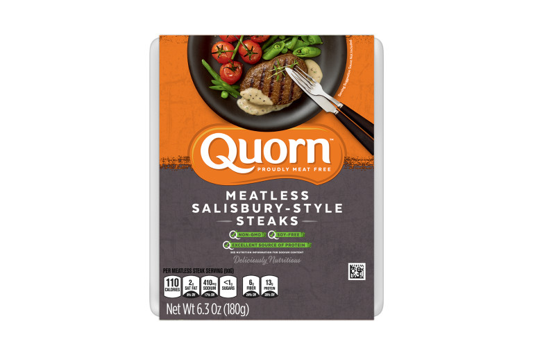 A package of Quorn Meatless Salisbury-Style Steaks showing the plated product and information on an orange and charcoal background.