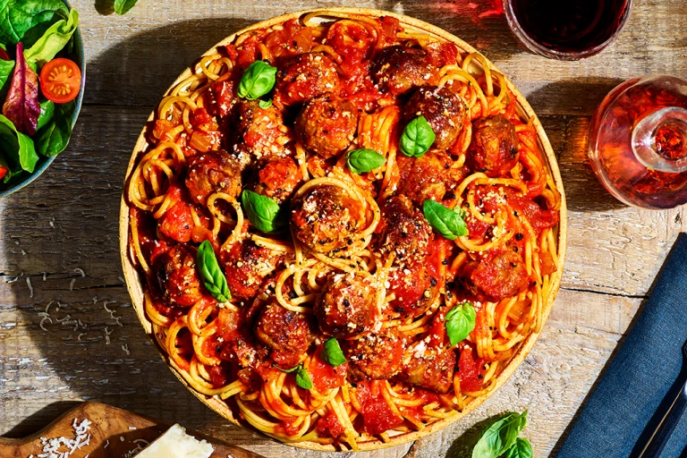 A bowl of vegetarian spaghetti and Quorn Swedish Style Balls in a tomato sauce.