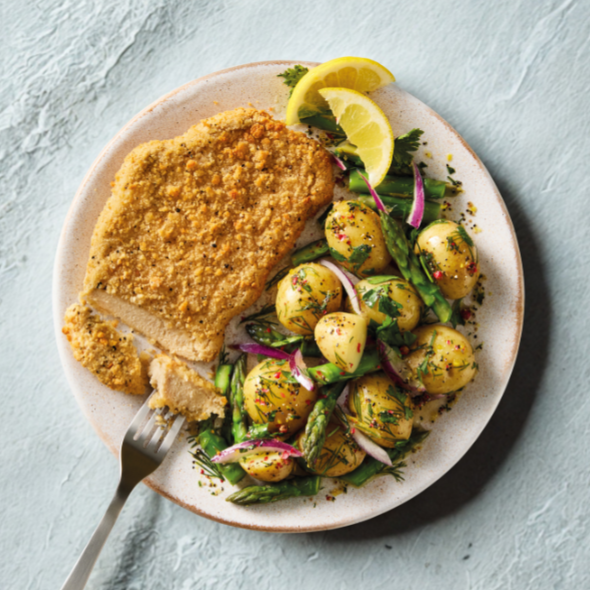 Quorn Lemon and Pepper Schnitzels, served with warm asparagus and potato salad.
