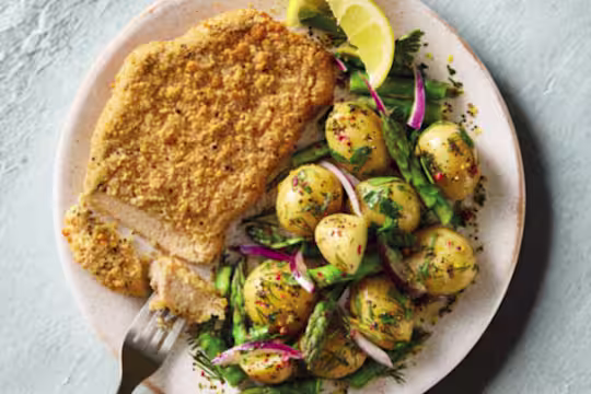 Quorn Lemon and Pepper Schnitzels, served with warm asparagus and potato salad.