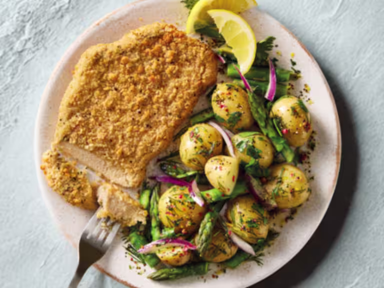 Quorn Lemon and Pepper Schnitzels, served with warm asparagus and potato salad.