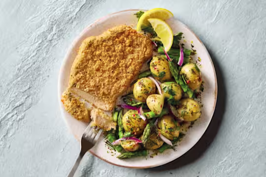 Quorn Lemon and Pepper Schnitzels, served with warm asparagus and potato salad.