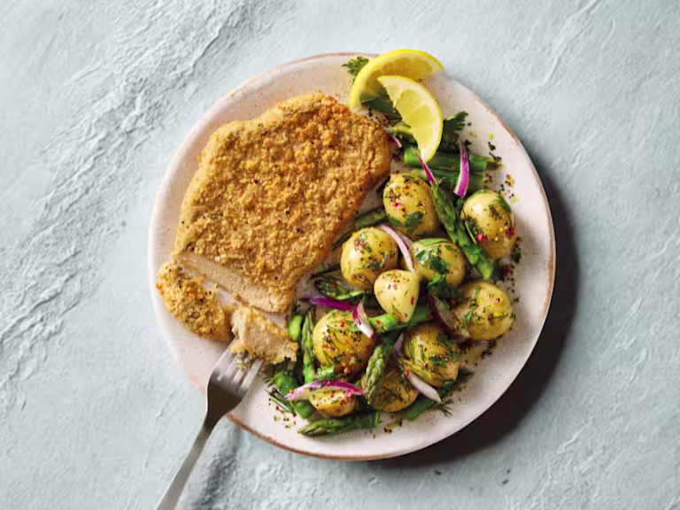 Quorn Lemon and Pepper Schnitzels, served with warm asparagus and potato salad.