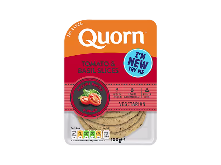 Orange Quorn Tomato & Basil Slices peel and reseal packaging, with a blue new product label and serving suggestion of panini, tomato and basil.