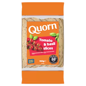 Orange Quorn Tomato & Basil Slices peel and reseal packaging, with a blue new product label and serving suggestion of panini, tomato and basil.