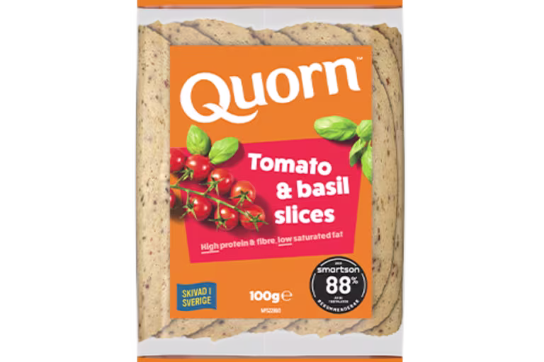 Orange Quorn Tomato & Basil Slices peel and reseal packaging, with a blue new product label and serving suggestion of panini, tomato and basil.