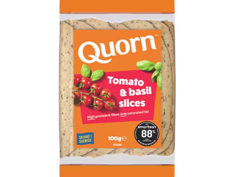 Orange Quorn Tomato & Basil Slices peel and reseal packaging, with a blue new product label and serving suggestion of panini, tomato and basil.