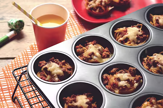 Easy meals for kids made with Quorn Mince on individual beds of spaghetti served in a muffin pan on top of a cooling rack