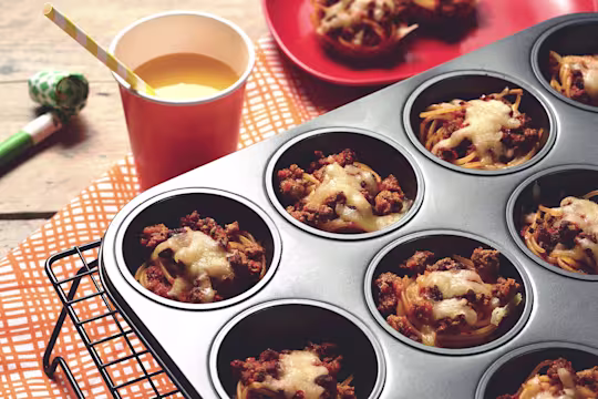 Easy meals for kids made with Quorn Mince on individual beds of spaghetti served in a muffin pan on top of a cooling rack
