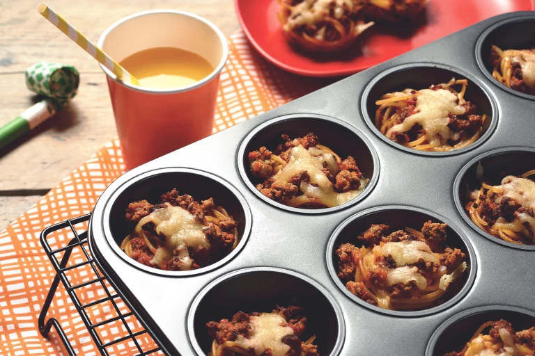 Easy meals for kids made with Quorn Mince on individual beds of spaghetti served in a muffin pan on top of a cooling rack
