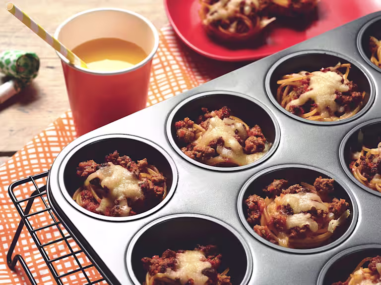 Easy meals for kids made with Quorn Mince on individual beds of spaghetti served in a muffin pan on top of a cooling rack