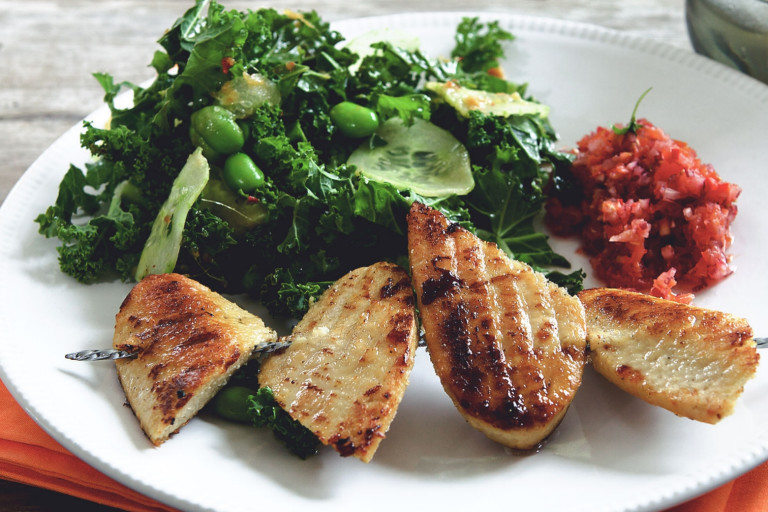Grilled Quorn Fillets served with a kale and edamame salad with cucumber slices on top and a pico de gallo salsa on the side.