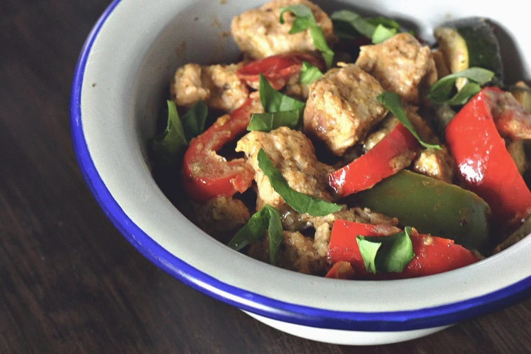 A dish of Quorn Pieces, peppers, and basil in a creamy Mediterranean sauce.
