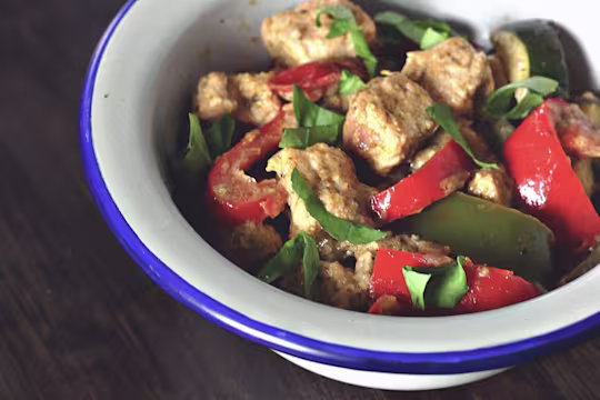 A dish of Quorn Pieces, peppers, and basil in a creamy Mediterranean sauce.