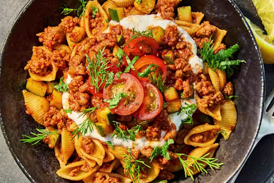 Vegetarian Turkish Pasta with Quorn Mince, courgette, cherry tomatoes, yoghurt, herbs and lemon served over shell pasta.