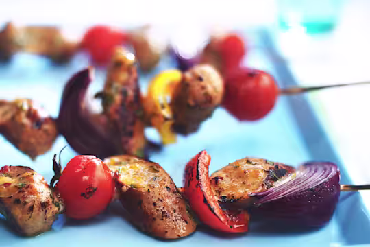 Skewers with Quorn Sausages, tomatoes, red onions, and red peppers.