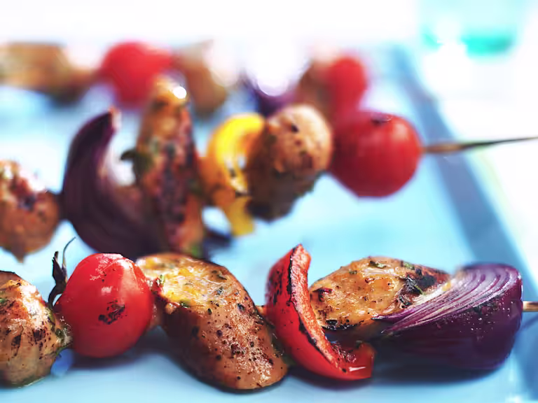 Skewers with Quorn Sausages, tomatoes, red onions, and red peppers.