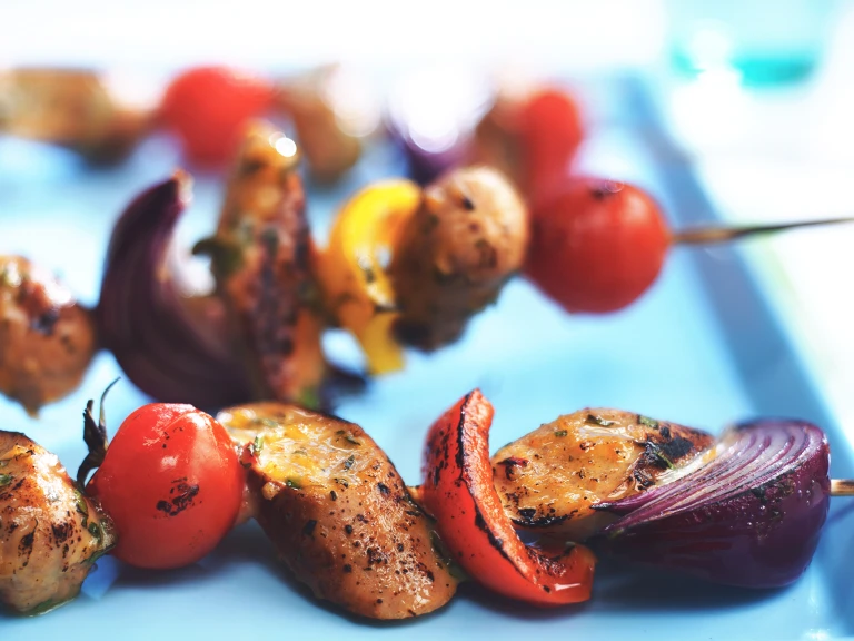 Skewers with Quorn Sausages, tomatoes, red onions, and red peppers.