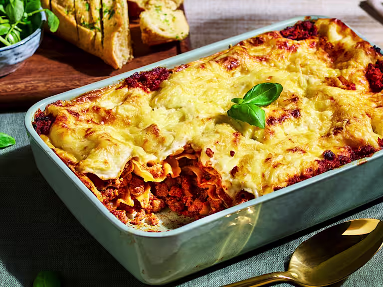 Vegetarian meatball recipe made with Quorn Swedish Style Balls served in a ceramic dish topped with creamy sauce and garnish