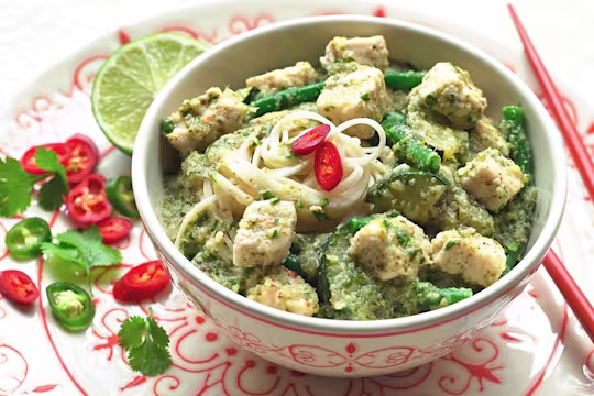 Thai curry made with vegetarian Quorn Pieces, noodles and green beans topped with sliced chilli, served in a bowl