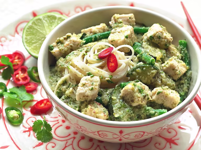 Thai curry made with vegetarian Quorn Pieces, noodles and green beans topped with sliced chilli, served in a bowl