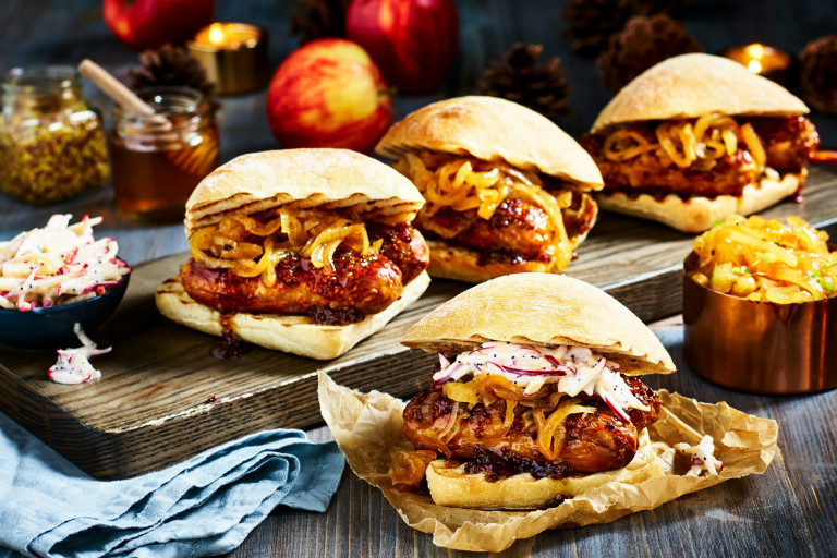 Four ciabatta buns filled with sticky marinated Quorn Best of British Sausages and caramelised onions with an apple slaw on the side.