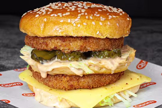 A double layered vegetarian chicken sits on Quorn branded paper