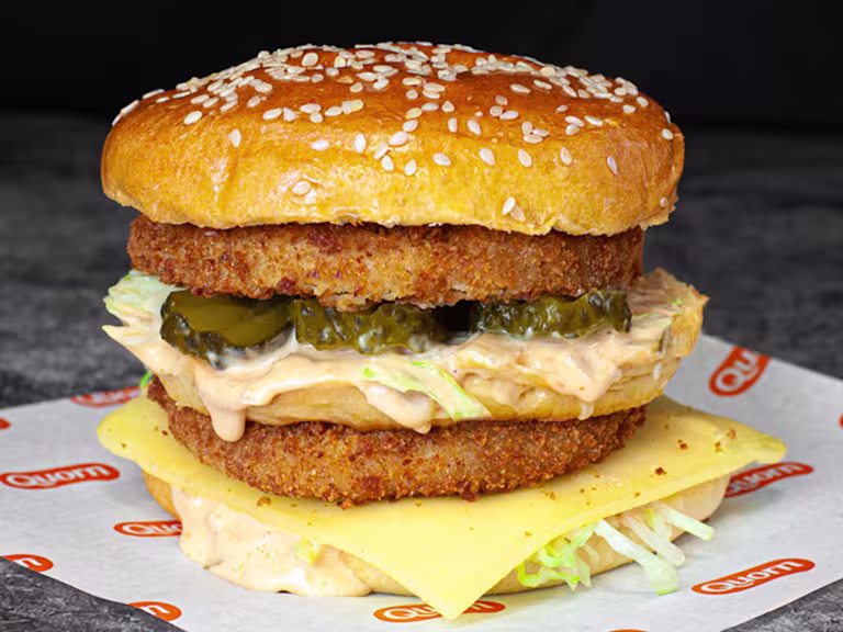 A double layered vegetarian chicken sits on Quorn branded paper