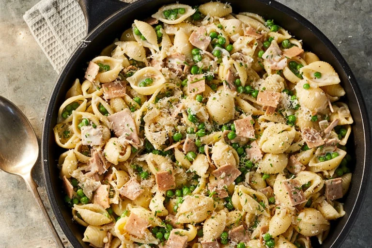 A large portion of Creamy Quorn Yorkshire Ham and Pea Vegan Pasta served in a dark dish.