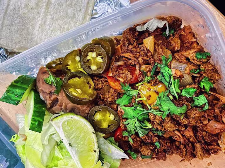 Quorn Vegetarian Mince and jackfruit mix in Tupperware with jalapenos, salad and fresh coriander.