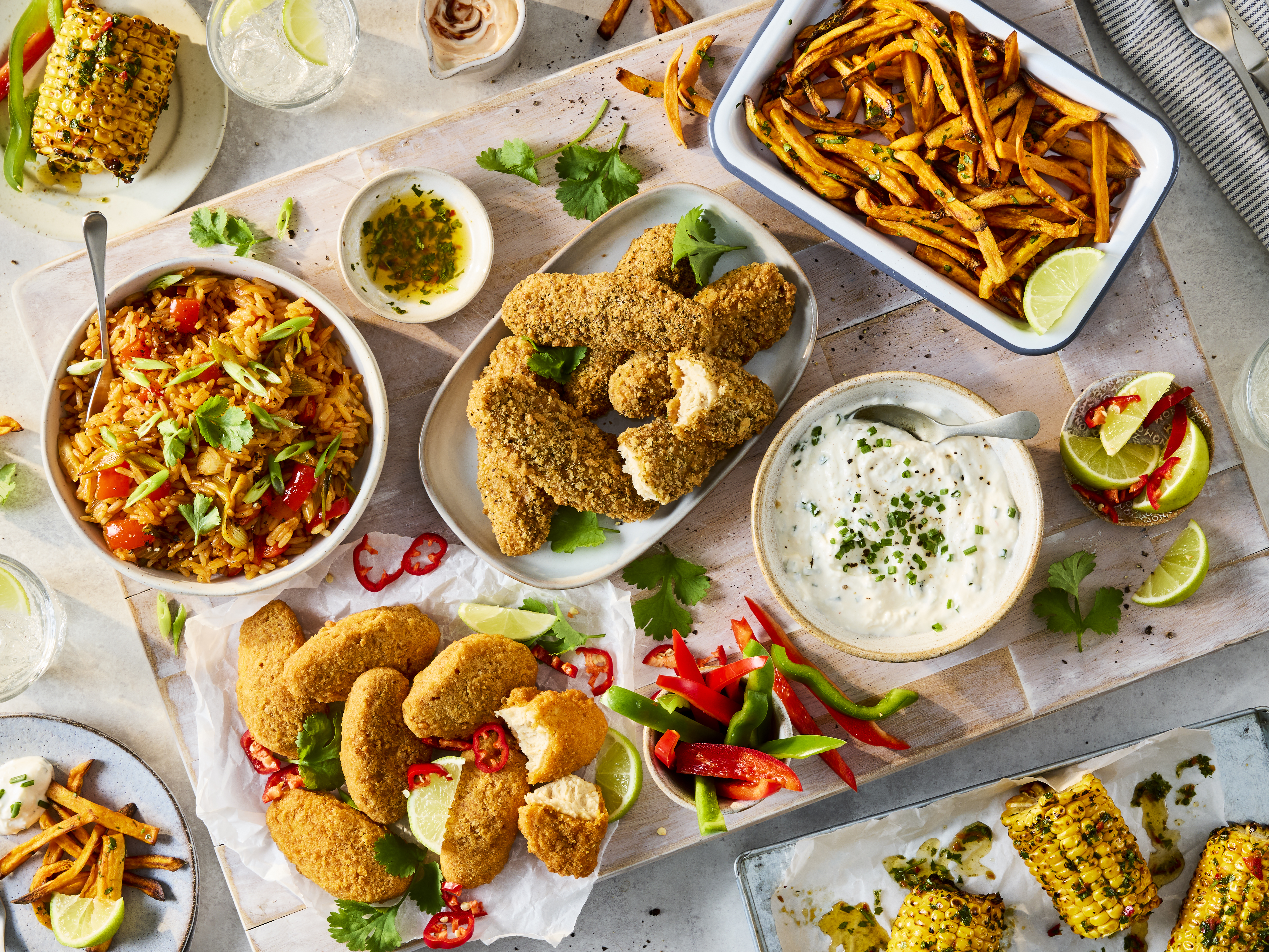 Sharing platter with Quorn Hot & Spicy Bites, Salt & Pepper Tenders, Korean fried rice, sweet potato fries, buffalo dip and chimichurri corn.