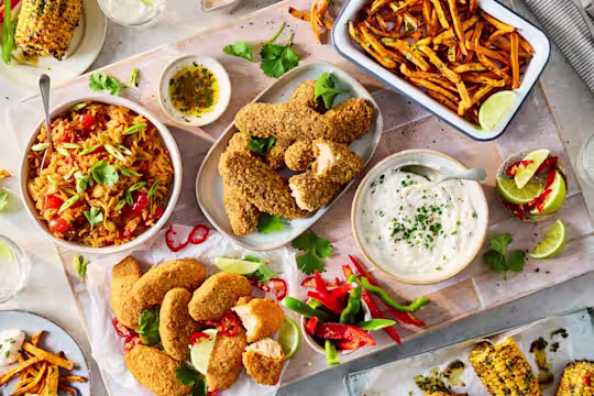 Sharing platter with Quorn Hot & Spicy Bites, Salt & Pepper Tenders, Korean fried rice, sweet potato fries, buffalo dip and chimichurri corn.