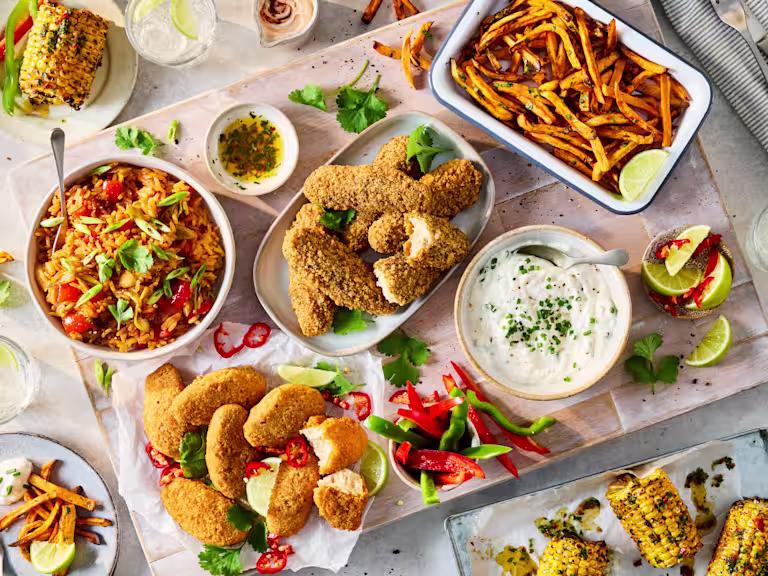 Sharing platter with Quorn Hot & Spicy Bites, Salt & Pepper Tenders, Korean fried rice, sweet potato fries, buffalo dip and chimichurri corn.