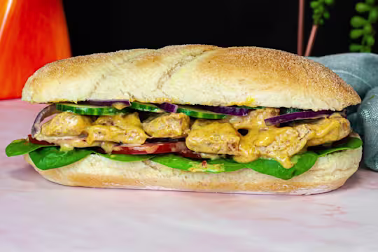 A soft white sub roll is filled with Quorn Fillets in a creamy, yellow Coronation dressing