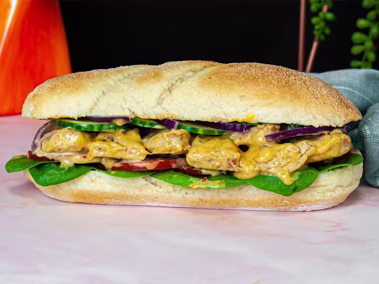 A soft white sub roll is filled with Quorn Fillets in a creamy, yellow Coronation dressing