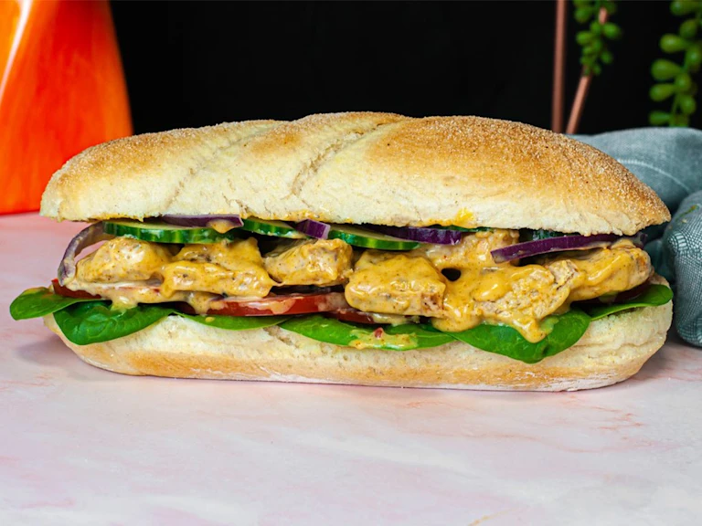 A soft white sub roll is filled with Quorn Fillets in a creamy, yellow Coronation dressing