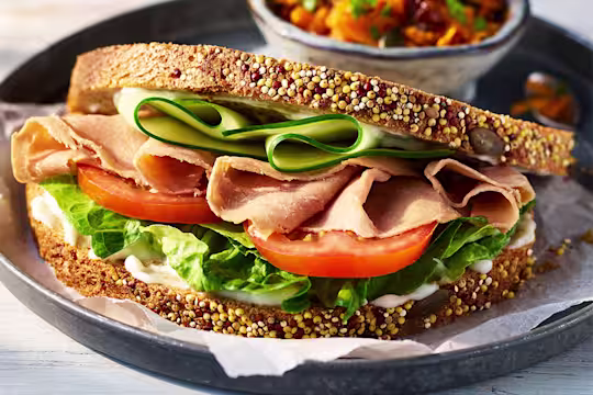 vegetarian ham salad sandwich with Quorn Vegetarian Ham Slices and salad on a black plate