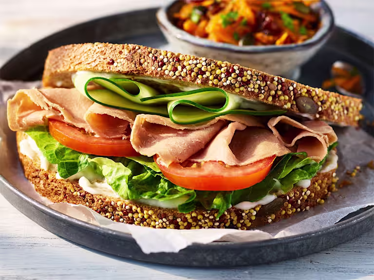 vegetarian ham salad sandwich with Quorn Vegetarian Ham Slices and salad on a black plate