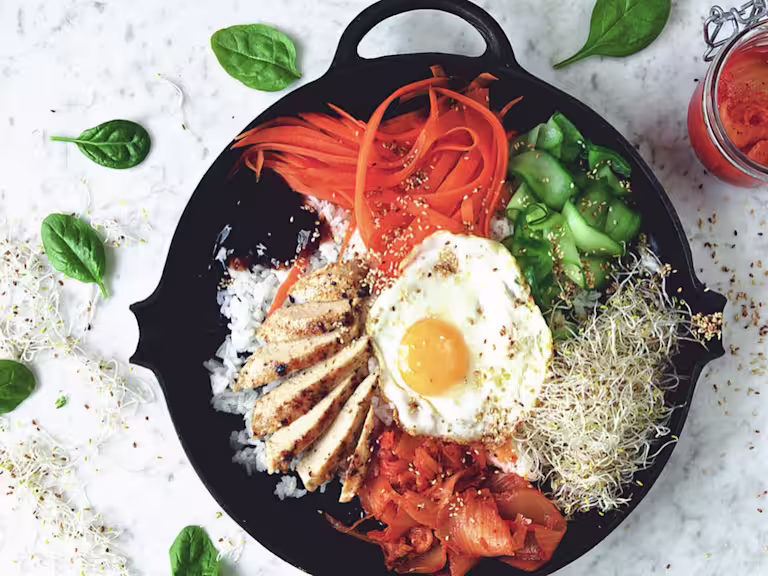 Vegetarian bibimbap made with Quorn Fillets served with rice, vegetables and egg in a skillet