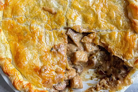 Quorn Pieces miso and mushroom pie with a piece removed in a dish