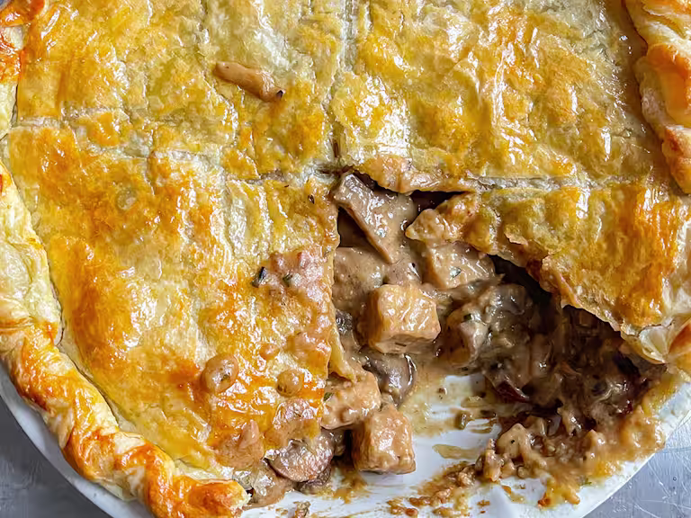 Quorn Pieces miso and mushroom pie with a piece removed in a dish