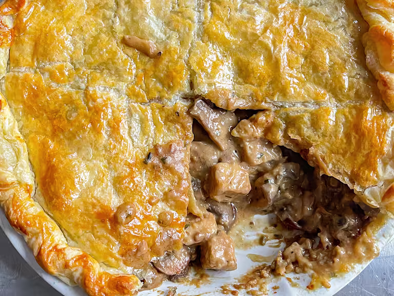 Quorn Pieces miso and mushroom pie with a piece removed in a dish