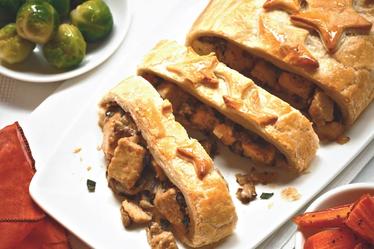 Vegetarian Christmas dishes made with Quorn Pieces, mushrooms and chestnuts stuffed in pastry and sliced, served on a plate