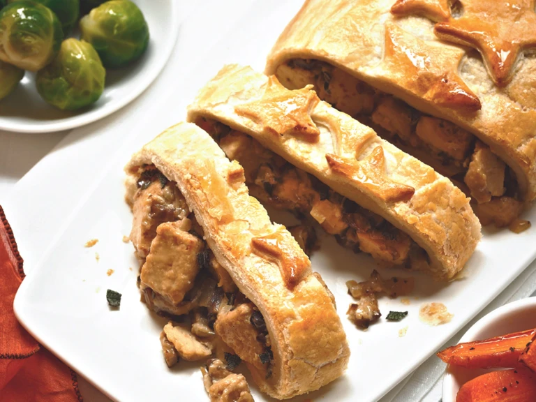 Vegetarian Christmas dishes made with Quorn Pieces, mushrooms and chestnuts stuffed in pastry and sliced, served on a plate