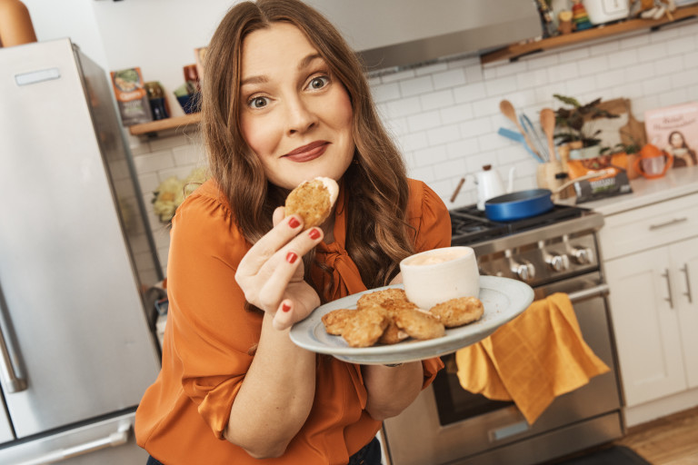 Drew Barrymore eating meatless chicken nuggets with sriracha mayo dip
