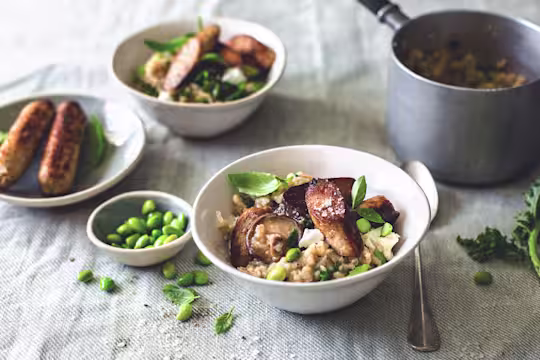 "A bowl of mushroom risotto made with creamy wild mushroom, kale & edamame beans and finished off with crisp Quorn sausages.