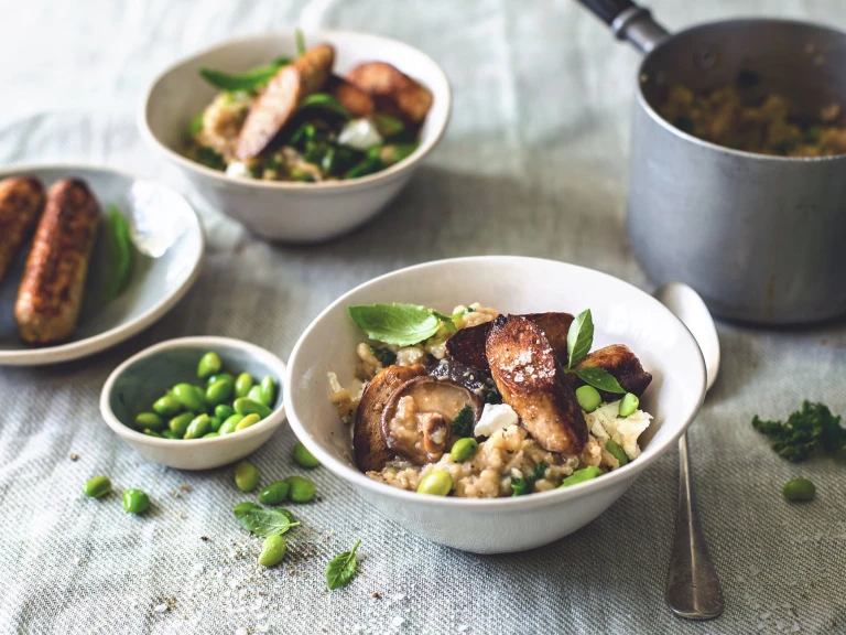 "A bowl of mushroom risotto made with creamy wild mushroom, kale & edamame beans and finished off with crisp Quorn sausages. 