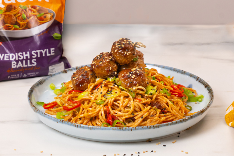 Sesame Glazed Quorn Swedish Meatballs served on top of a bed of chilli noodles.