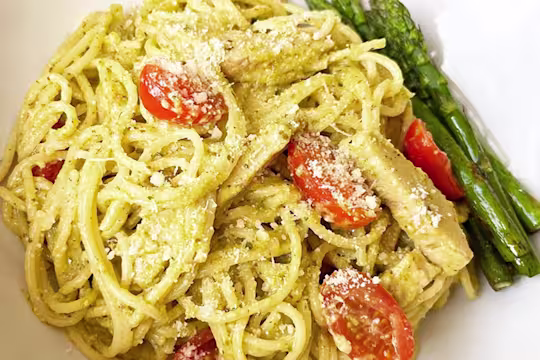 Creamy pasta served with chopped tomatoes and asparagus.