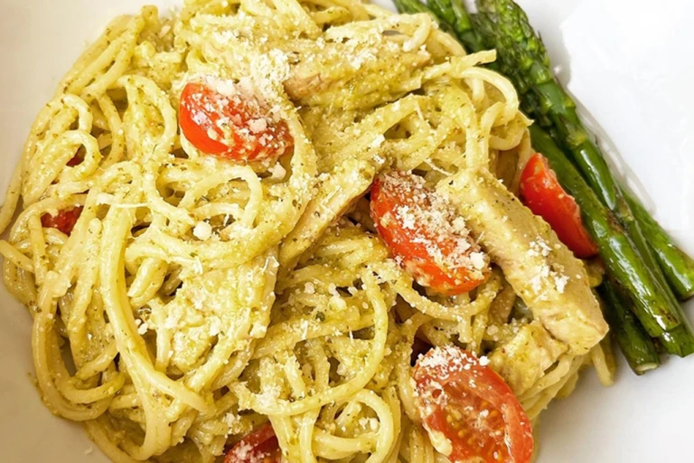 Creamy pasta served with chopped tomatoes and asparagus.